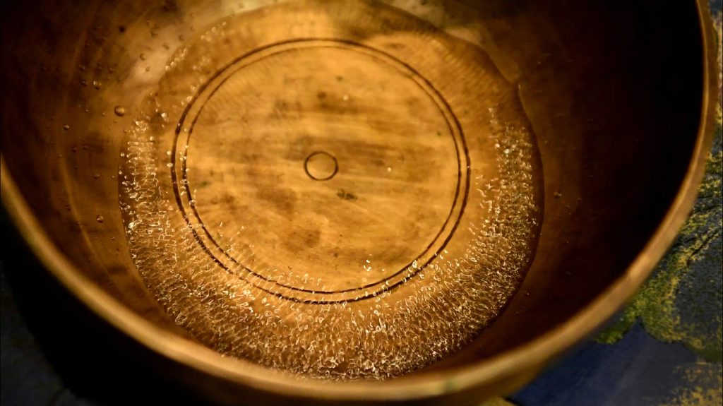 water vibrating in a sound bowl with Natural Tuning